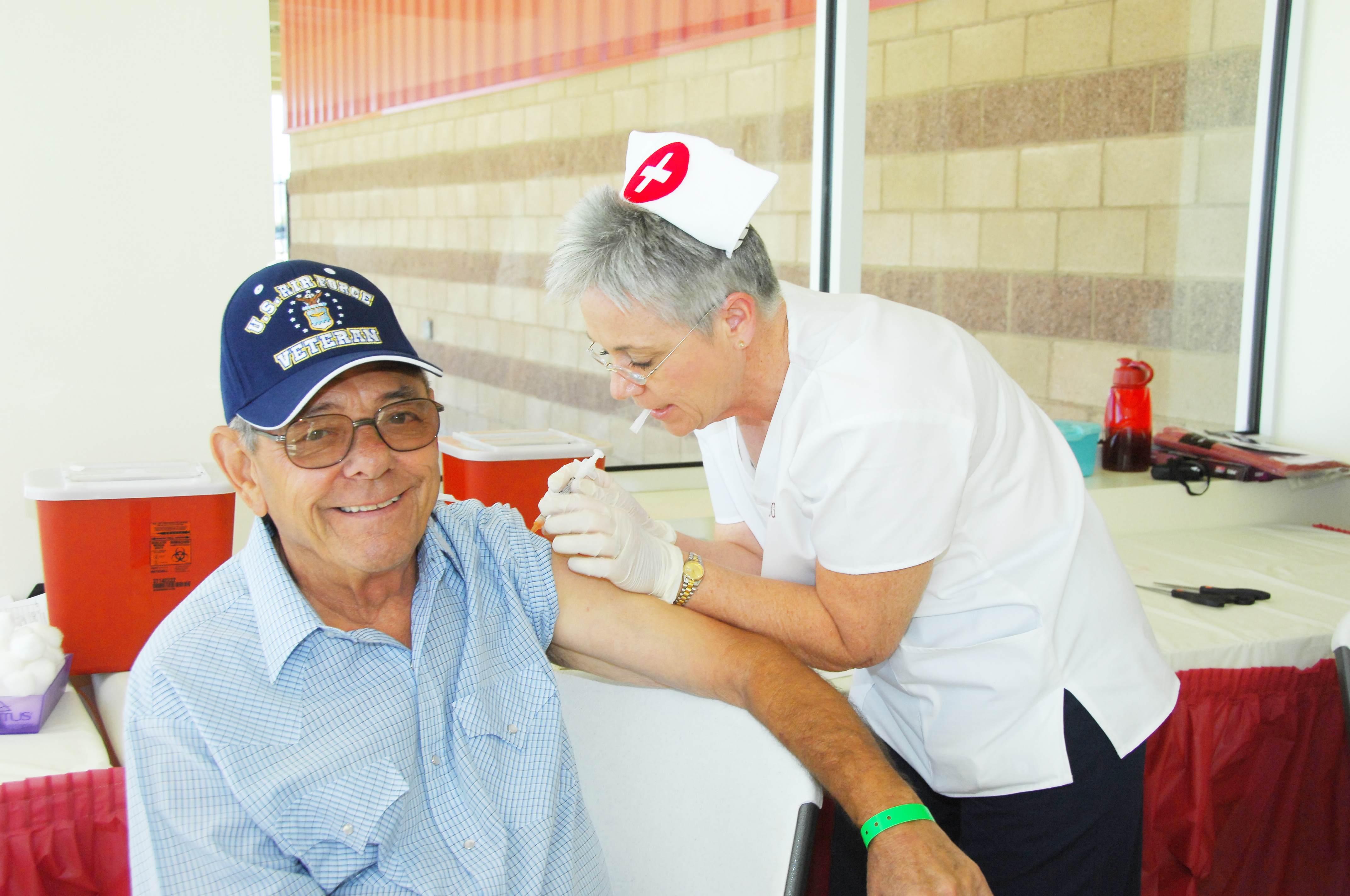 Nurse giving senior flu shot